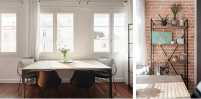 a dining room with a table and a brick wall at Central Cannes Loft - 15 min Palais des Festivals in Cannes