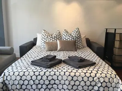 a bed with two black towels on top of it at Central Cannes Loft - 15 min Palais des Festivals in Cannes