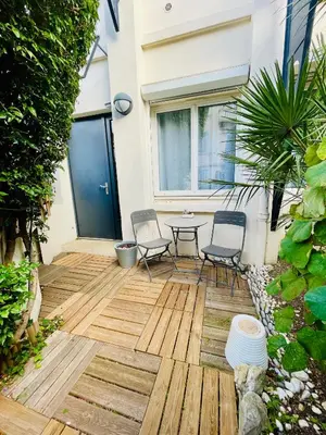 a patio with chairs and a table in a house at Central Cannes Loft - 15 min Palais des Festivals in Cannes