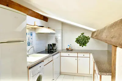 a kitchen with white cabinets and a sink at Le Napoléon 3P SAM1437 in Cannes