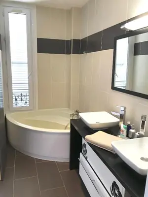 a bathroom with a tub and a sink and a mirror at Cannes Festival in Cannes