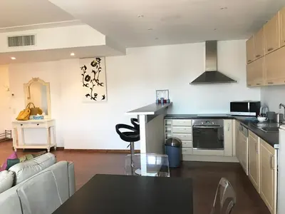 a kitchen and living room with a table and a couch at Cannes Festival in Cannes