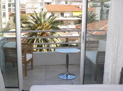 a balcony with a table and a view of a city at Palais Rouaze Cannes in Cannes