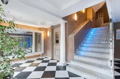 a staircase in a house with a checkered floor at Palais Rouaze Cannes in Cannes