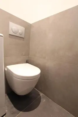 a bathroom with a white toilet in a room at Cosy-Cocoon in Cannes