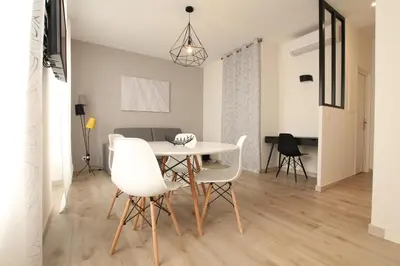 a dining room with a white table and chairs at Cosy-Cocoon in Cannes
