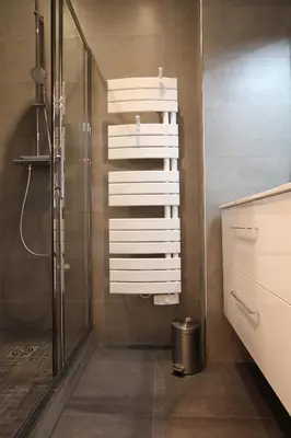 a bathroom with a shower and white towels at Cosy-Cocoon in Cannes
