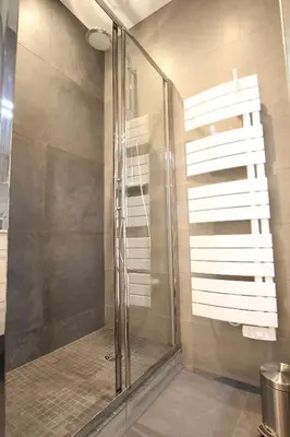 a shower with a glass door in a bathroom at Cosy-Cocoon in Cannes