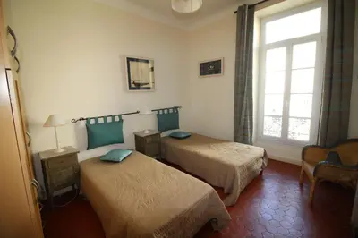 a hotel room with two beds and a window at AGENCIA apartement 3 PIECES RUE D'ANTIBES in Cannes