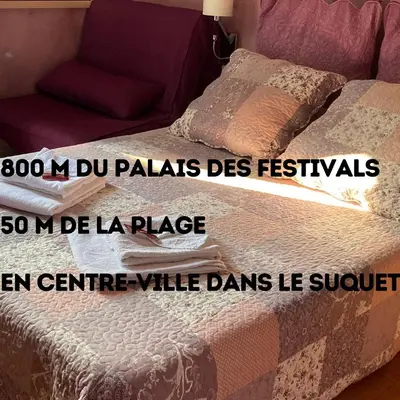 a bedroom with a bed with a couch and a table at Boutique Hotel Couleurs Suds in Cannes