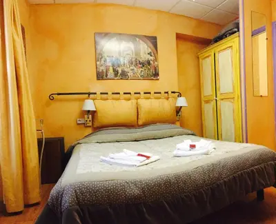 a bedroom with a bed with two towels on it at Boutique Hotel Couleurs Suds in Cannes
