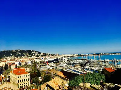 a view of a city with a harbor and the water at Boutique Hotel Couleurs Suds in Cannes