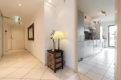 a living room with a lamp on a dresser at Appartement de charme à Cannes + terrasse in Cannes