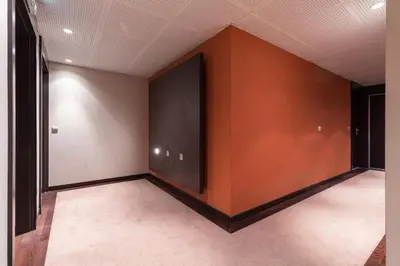an empty room with orange walls and a large window at Appartement de charme à Cannes + terrasse in Cannes