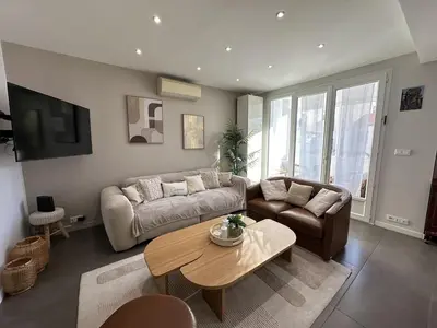 a living room with a couch and a table at Cannes center perfect 3 bedroom in Cannes