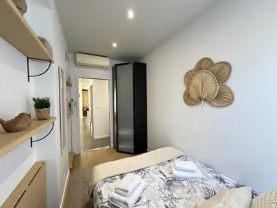 a bedroom with a bed and a mirror on the wall at Cannes center perfect 3 bedroom in Cannes