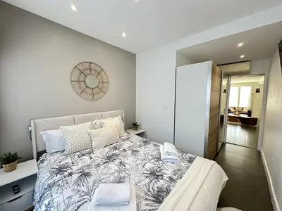 a bedroom with a large bed in a room at Cannes center perfect 3 bedroom in Cannes