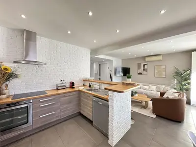 a kitchen and living room with a counter and a couch at Cannes center perfect 3 bedroom in Cannes