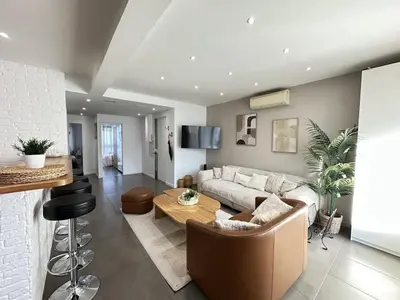 a living room with a couch and a table at Cannes center perfect 3 bedroom in Cannes