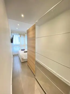 a bedroom with a sliding door with a bed at Cannes center perfect 3 bedroom in Cannes
