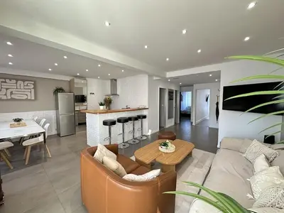 a living room with a couch and a table at Cannes center perfect 3 bedroom in Cannes