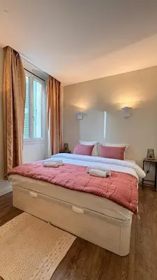 a bedroom with a large bed with red sheets at Le Saint-Pierre PET231 2P in Cannes