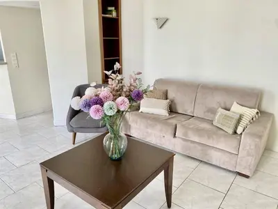 a vase of flowers on a coffee table in a living room at Le Saint-Pierre PET231 2P in Cannes