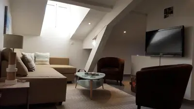 a living room with a couch and a flat screen tv at Cannes,croisette,palais des festivals,plages in Cannes
