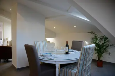 a dining room with a table with a bottle of wine at Cannes,croisette,palais des festivals,plages in Cannes
