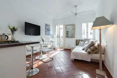 a living room with a white couch and a table at A lovely split level townhouse in the heart of Cannes next to the Marche Forville and the Palais 1749 in Cannes