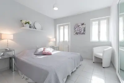 a living room with a white couch and a table at A lovely split level townhouse in the heart of Cannes next to the Marche Forville and the Palais 1749 in Cannes