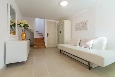 a living room with a couch and a mirror at A lovely split level townhouse in the heart of Cannes next to the Marche Forville and the Palais 1749 in Cannes