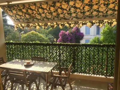 a table and chairs on a patio with a fence at Amazing Studio Cannes Center - Terrassse - 5 min Croisette in Cannes
