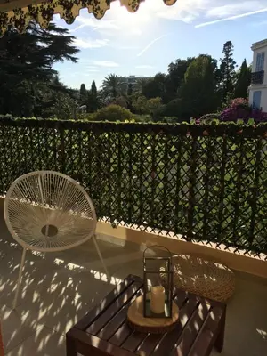 a patio with a fan and a table and a chair at Amazing Studio Cannes Center - Terrassse - 5 min Croisette in Cannes