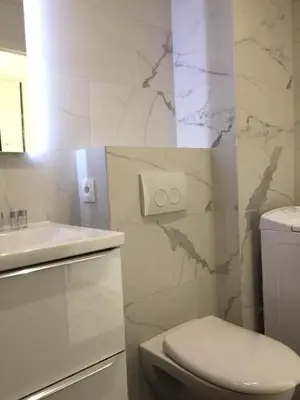 a white bathroom with a toilet and a sink at Amazing Studio Cannes Center - Terrassse - 5 min Croisette in Cannes