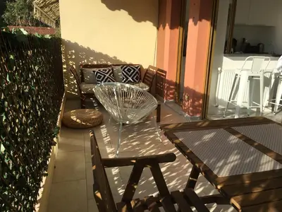 a glass table and a chair on a balcony at Amazing Studio Cannes Center - Terrassse - 5 min Croisette in Cannes