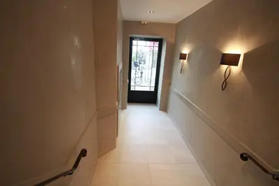an empty hallway with a door and a hallwayngthngthngthngthngthngthngth at Palais Foch in Cannes