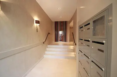 a hallway with a staircase and a stair case at Palais Foch in Cannes