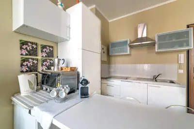 a kitchen with white cabinets and a white counter top at IMMOGROOM - Historic Area Le Suquet - 6min from the beaches in Cannes