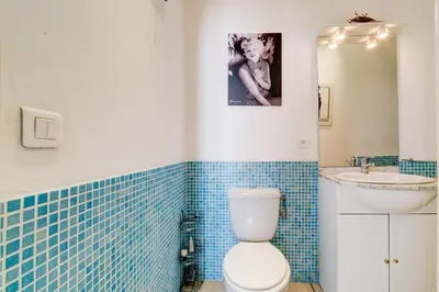 a bathroom with a toilet and a sink at IMMOGROOM - Historic Area Le Suquet - 6min from the beaches in Cannes