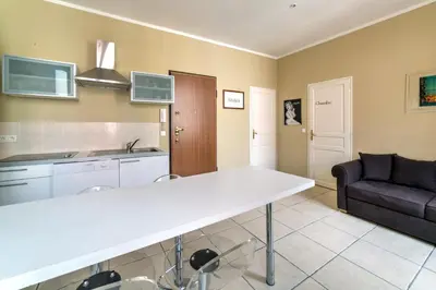 a kitchen and living room with a large white counter top at IMMOGROOM - Historic Area Le Suquet - 6min from the beaches in Cannes