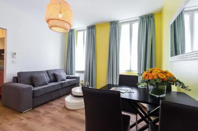 a living room with a couch and a table at Florella Clemenceau Apartment in Cannes