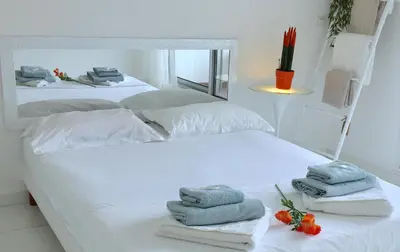 two beds with towels on them in a bedroom at Appartements Cannes in Cannes