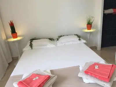 a white bed with two towels on top of it at Appartements Cannes in Cannes