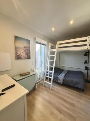 a bedroom with a bunk bed and a desk at Résidence Gambetta in Cannes