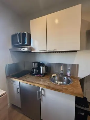a kitchen with a sink and a microwave at Résidence Gambetta in Cannes