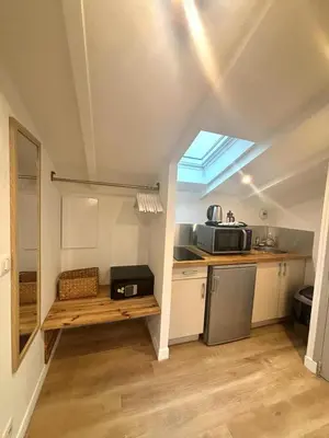 a small kitchen with a sink and a microwave at Résidence Gambetta in Cannes