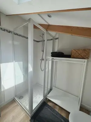 a walk in shower with a glass enclosure at Résidence Gambetta in Cannes