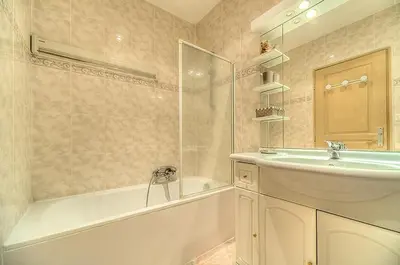 a bathroom with a sink and a bath tub and a sink at Residence Chryseis in Cannes