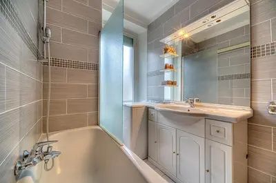 a bathroom with a tub and a sink and a mirror at Residence Chryseis in Cannes